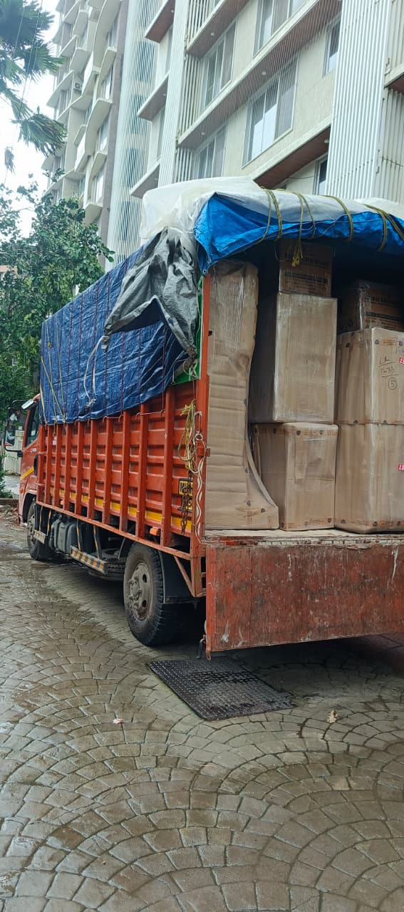 Just Home Packers and Movers truck loaded outside an apartment building in Ghatkopar